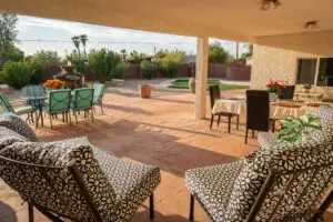 A patio with chairs and tables.