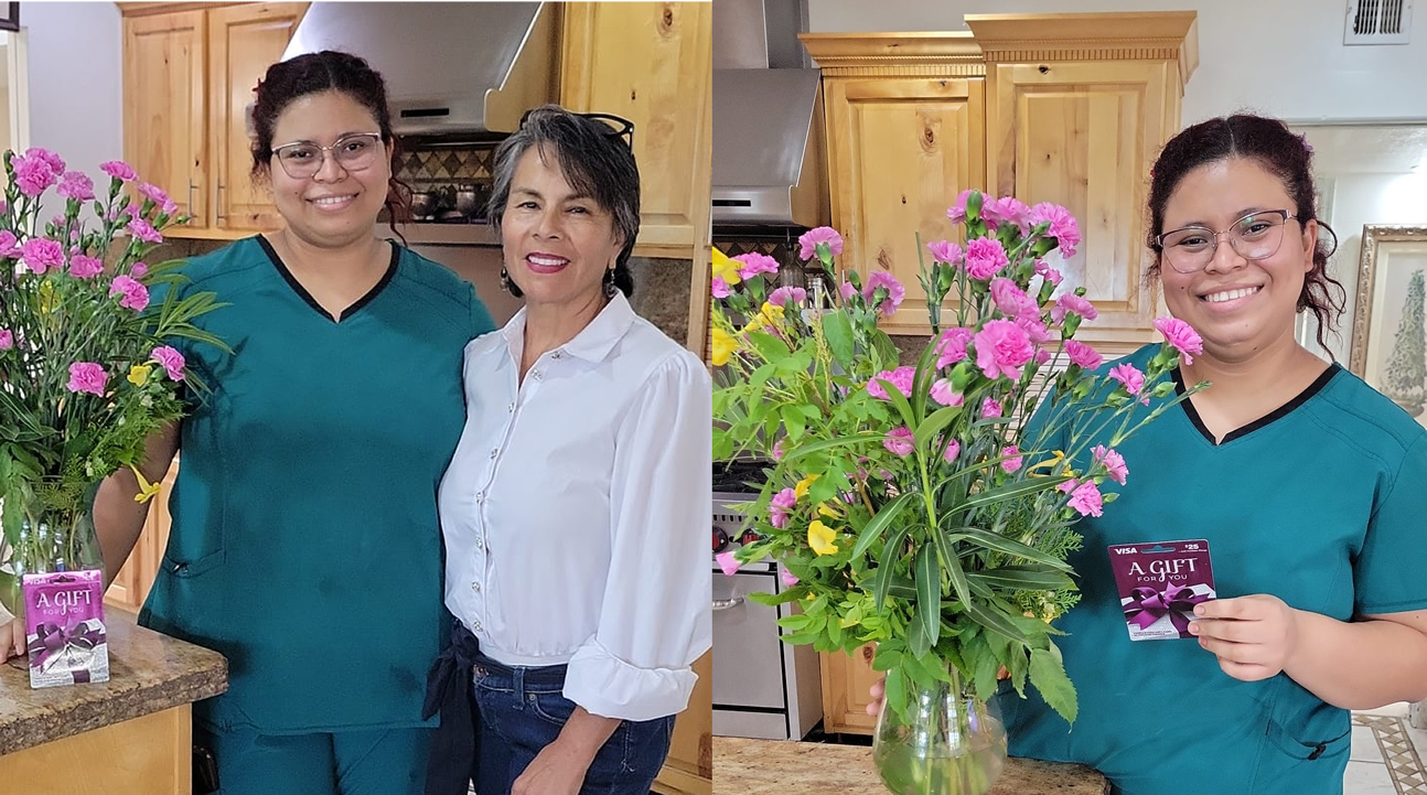 A skilled nurse and our senior standing next to a flower inside the vase.